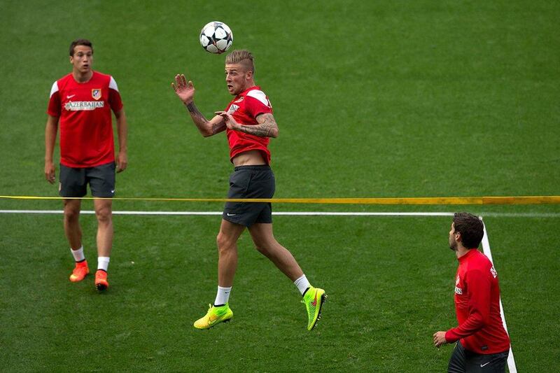 Toby Alderweireld of Atletico Madrid heads the ball as teammate Javier Manquillo, left, looks on at the Atletico training session on Monday as the club prepare to face Real Madrid in Saturday's Champions League final. Gonzalo Arroyo Moreno / Getty Images / May 19, 2014