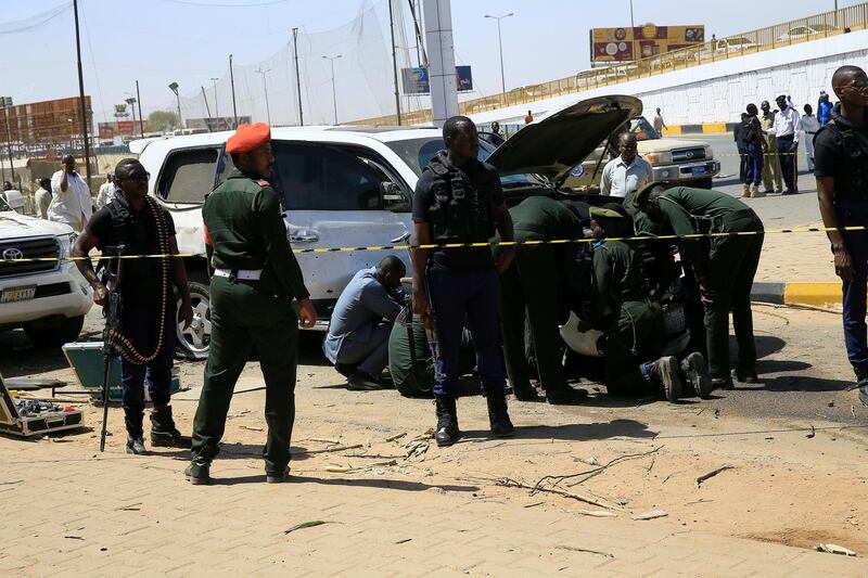 Security personnel stand near a car damaged after an explosion targeting the motorcade of Sudan's Prime Minister Abdalla Hamdok near the Kober Bridge in Khartoum, Sudan. Reuters