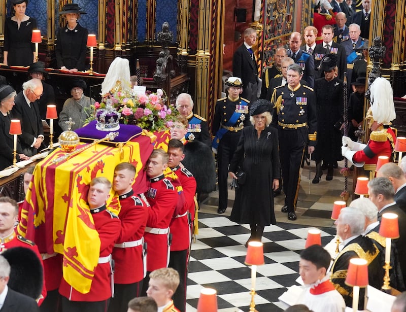 The coffin of Queen Elizabeth is carried into Westminster Abbey, followed by King Charles and Queen Consort Camilla for the state funeral in London. PA