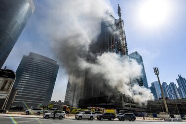 Smoke rises from a fire in a tower in the Business Bay area of Dubai. Karim Sahib / AFP