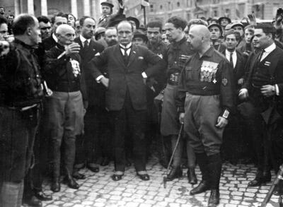 Italian Fascist leader Benito Mussolini, centre, hands on hips, with members of the Fascist Party, in Rome, on October 28, 1922, following their March on Rome.  The Brothers of Italy party, the biggest vote-getter in Italy's national election, has its roots in the post-World War II neofascist Italian Social Movement. It went from a fringe far-right group to the biggest party in Italian politics. AP