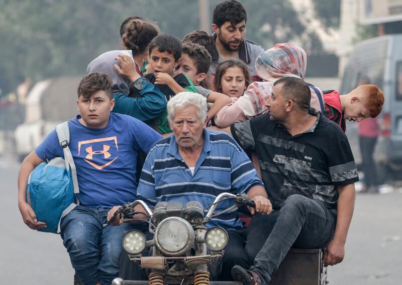 Palestinians flee after Israeli strikes in the northern and eastern Gaza Strip on Sunday. EPA