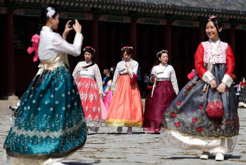 Foreign tourists wearing traditional Korean costumes at the Gyeongbok palace during the Chuseok holidays in Seoul, South Korea. Jeon Heon-Kyun/EPA