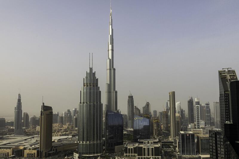 The Burj Khalifa skyscraper, center, towers above commercial and residential properties in Dubai, United Arab Emirates, on Tuesday, July 23, 2019. Like the rest of the city, the business center has suffered from a prolonged real-estate slump brought on by oversupply and slower economic growth. Photographer: Christopher Pike/Bloomberg