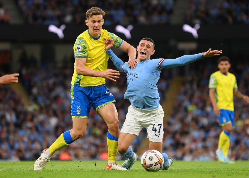 City attacker Phil Foden goes down from the challenge by Ryan Yates of Forest. Getty