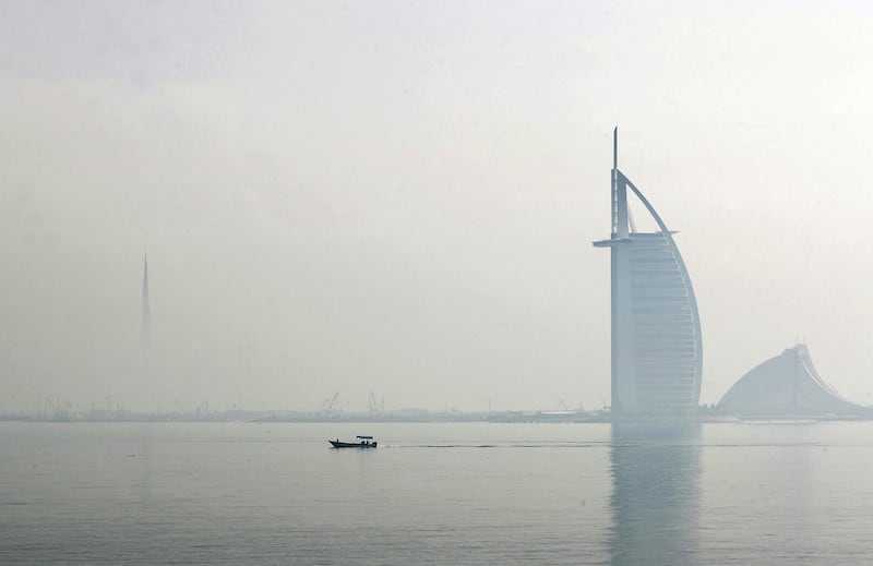 Dubai, United Arab Emirates - Reporter: N/A: Weather. Fog and mist cover the Burj Al Arab and the Burj Khalifa as a boat goes passed. Wednesday, April 8th, 2020. Dubai. Chris Whiteoak / The National