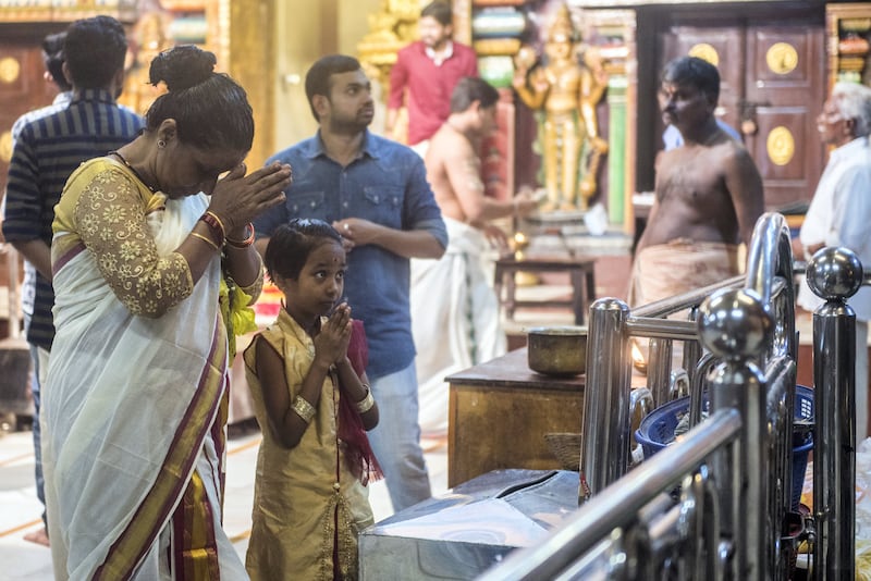 MUMBAI, INDIA - SEPTEMBER 4: Devotees pray on the occasion of Onam at Astik Samaj Temple, Matunga on September 4, 2017 in Mumbai, India. Onam is an annual harvest festival of Kerala. The festival is mainly celebrated by Malayalees around the world with traditional folk dances, artworks, etc. According to the Onam story and its popular myth, Lord Vishnu in his Vamana avtar sents King Mahabali to hell as the gods becomes jealous of his popularity. But grants him a boon that the king can visit his subjects once in a year. Thus, it is believed that Onam is celebrated as King Mahabali's visit to the place. It is the only festival in which both the winner and the defeater are worshipped. Onam Festival falls during the Malayali month of Chingam (Aug - Sep) and marks the homecoming of legendary King Mahabali. Carnival of Onam lasts for ten days and brings out the best of Kerala culture and tradition. (Photo by Pratik Chorge/Hindustan Times via Getty Images)