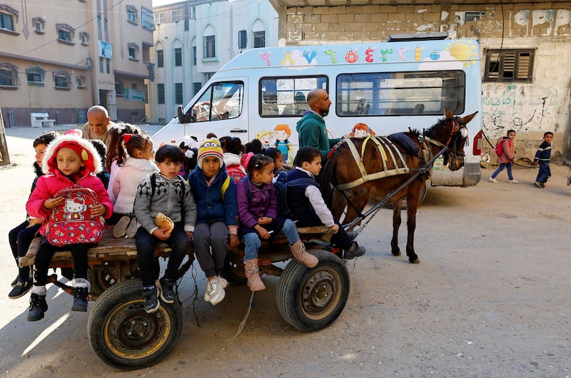 A Palestinian man offers children in kindergarten a cheap ride on his donkey-drawn cart in Gaza. Reuters