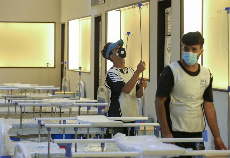 Iraqi volunteers with the Aqiq Institution for Charity work on building a 525-bed field hospital at the Baghdad International Fair exhibition centre in the capital Baghdad.  AFP