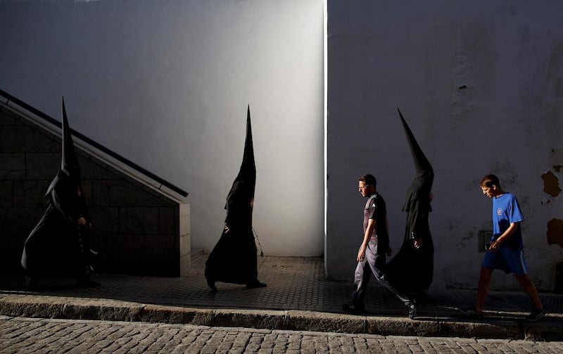 Penitents from ‘El Museo’ brotherhood walk to the church to start a procession in Seville, Spain. Easter week is traditionally celebrated with processions in most Spanish towns. Pablo Blazquez Dominguez / GETTY  