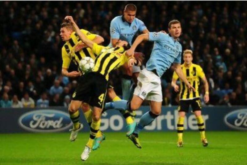 Lukasz Piszczek, left, and his Borussia Dortmund teammates were unlucky to leave Manchester with only a point off a 1-1 draw against City in their Champions League match.