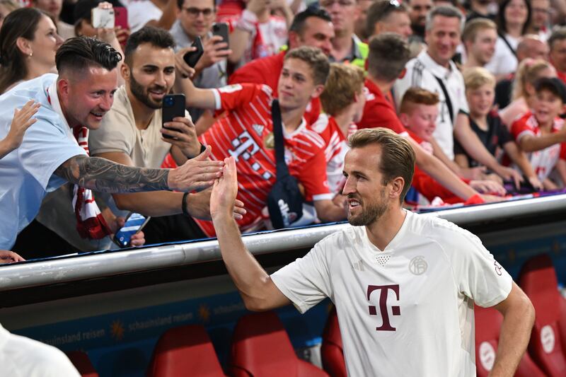 Harry Kane shakes hands with supporters ahead of the German Super Cup. PA