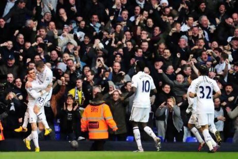 Gareth Bale, left, celebrates scoring the opening goal with Gylfi Sigurdsson as more of their Tottenham Hotspur teammates run to join them.
