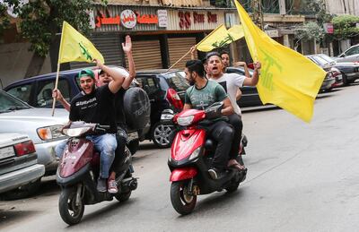 epa06715567 Supporter of Hezbollah carry their party flags and ride motorcycles at the southern suburb of Beirut, Lebanon, 06 May 2018. There are 976 candidates, including 111 women, competing for 128 seats in parliament divided equally between the Muslim and Christian sects,  during the general parliamentary elections after nine years of forced extension, through a new electoral law that adopts the percentage.  EPA/NABIL MOUNZER