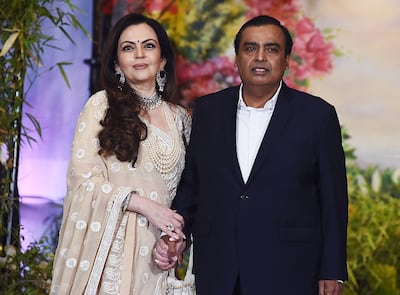 Indian businessman Mukesh Ambani and his wife Nita, who will be stepping down from the board of Reliance Industries. AFP 