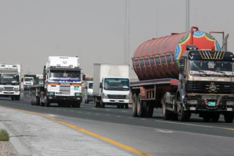 DUBAI, UNITED ARAB EMIRATES - March 31: Trucks heading in the direction of Jebel Ali from Dubai on Emirates road in Dubai on March 31, 2008. ( Randi Sokoloff / The National ) *** Local Caption *** na17truck1.jpg
