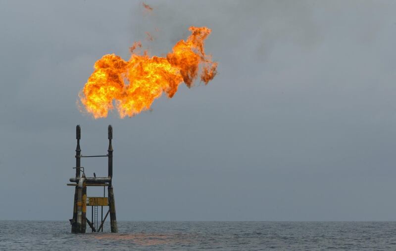 (FILES) In this file photo taken on October 13, 2003 flames rise from a Total Elf Fina offshore oil rig off the Angolan coast.  World oil prices jumped on January 3, 2020 after the US killed a top Iranian general, fanning fresh fears of conflict in the crude-rich Middle East, with Tehran warning of "severe" retaliation. / AFP / Martin BUREAU
