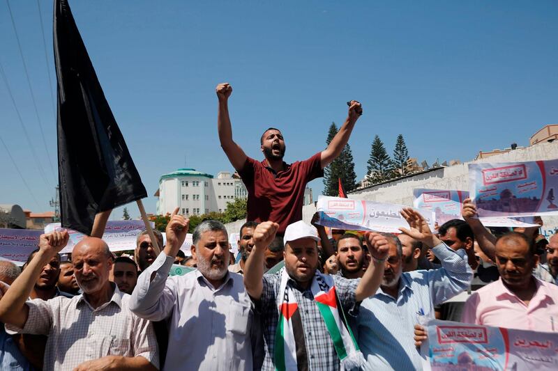 Palestinians in Gaza City shout slogans during a protest against a US-sponsored Middle East economic conference in Bahrain on June 26, 2019. / AFP / MOHAMMED ABED
