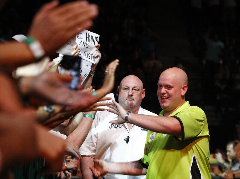 Michael van Gerwen shakes hands with fans on his way to the stage at the Dubai Duty Free Darts Masters. Jeffrey E Biteng / The National