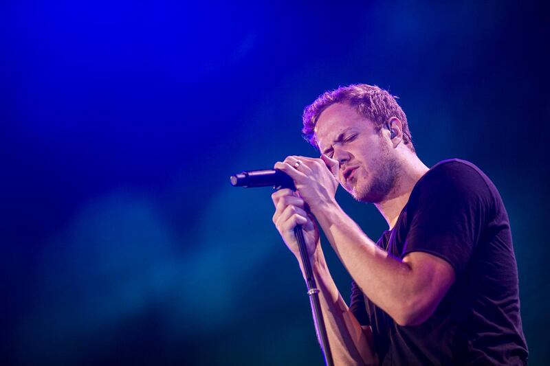 HONG KONG - JUNE 19:  Dan Reynolds of Imagine Dragons performs on stage at the Ocean Terminal Rooftop Car Park to celebrate the worldwide premiere screening of "Transformers: Age of Extinction" on June 19, 2014 in Hong Kong, Hong Kong.  (Photo by Jerome Favre/Getty Images for Paramount)