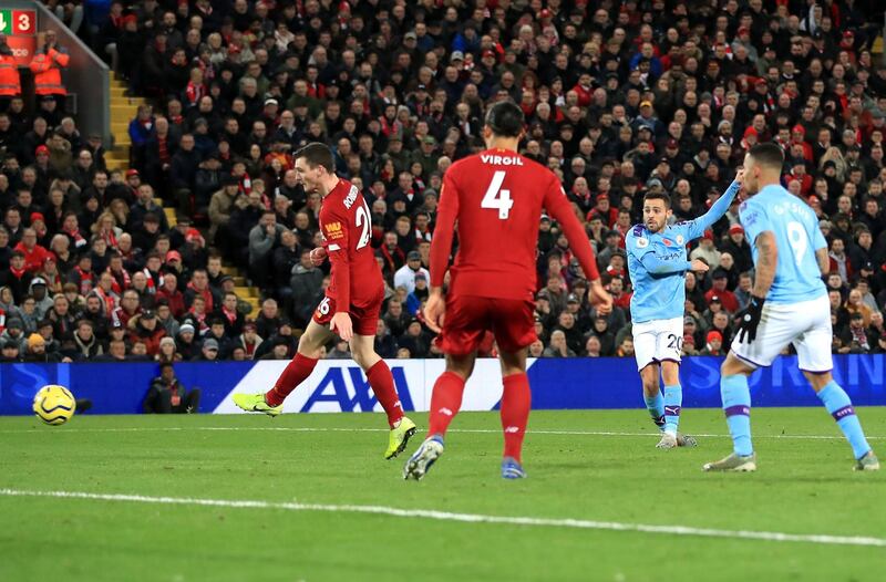 Manchester City's Bernardo Silva, centre right, scores his side's first goal against Liverpool at Anfield. PA