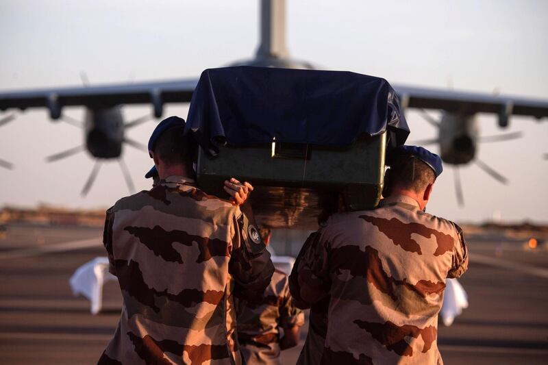 French soldiers of the Barkhane force carrying the coffin of a soldier who died when two French military helicopters collided in Mali. AFP