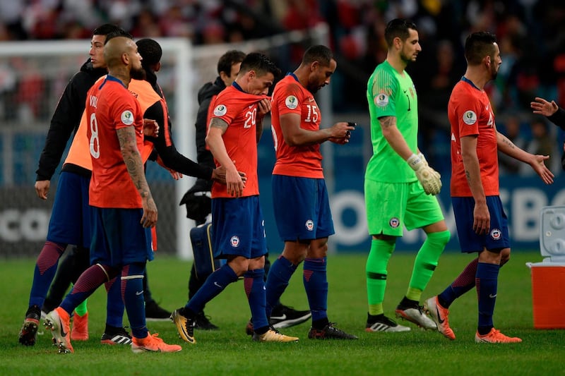 Players of Chile leave the field in dejection after losing 3-0 to Peru in their Copa America football tournament semi-final match at the Gremio Arena in Porto Alegre, Brazil.  AFP