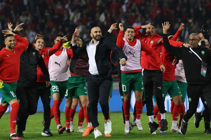 Morocco manager Walid Regragui, centre, celebrates with his players after their 2-1 friendly win over Brazil at the Ibn Batouta Stadium in Tangier on March 26, 2023. AFP