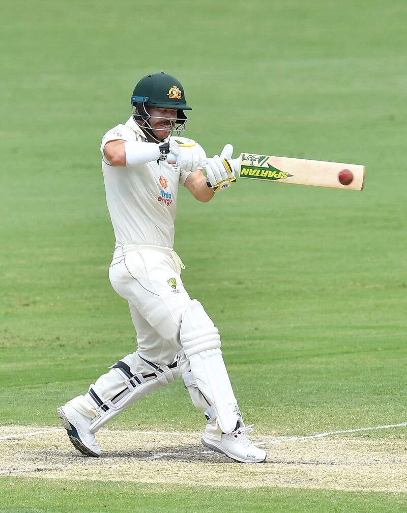 Australia opener David Warner hits a four on his way to 48 at the Gabba.