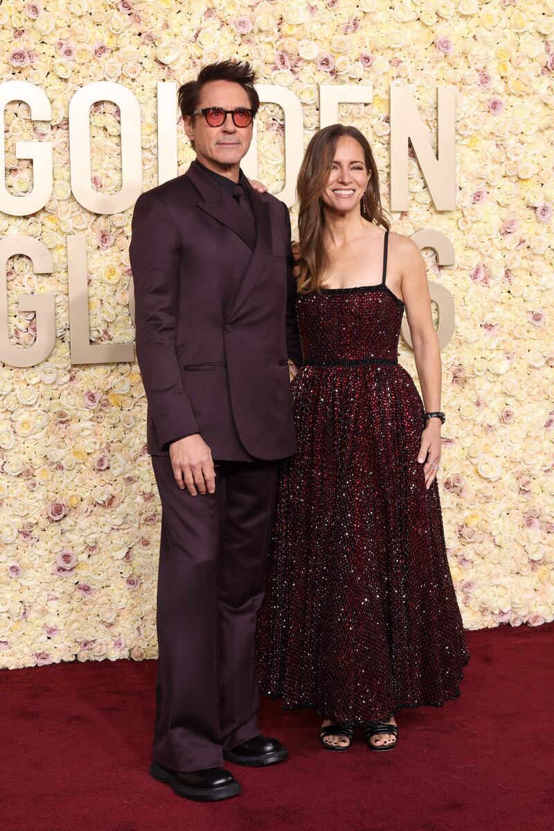 Robert Downey Jr and his wife Susan Downey in matching plum. Getty Images via AFP