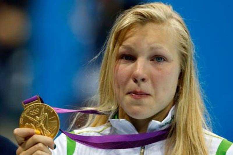 Lithuania's 15-year-old swimmer Ruta Meilutyte poses with her gold medal after winning the 100m breaststroke final at London 2012