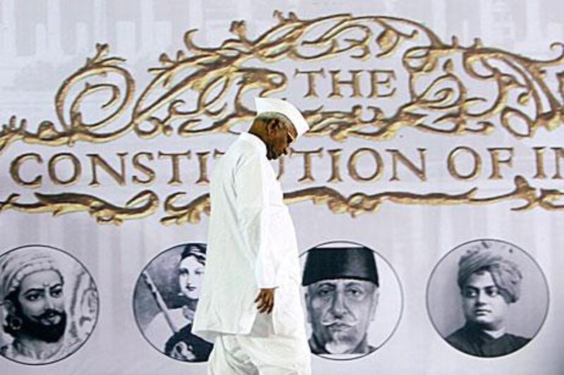Anna Hazare, the leader of India's anti-corruption movement, walks on stage last month to tell his followers that he would end his fast a day earlier than planned.