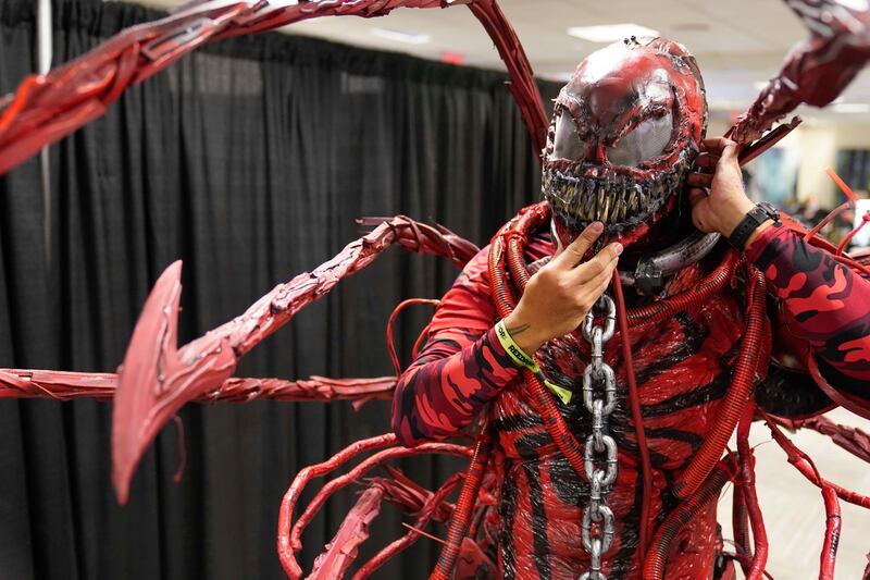Fabian Pulgar dons the mask to his Carnage costume at the New York Comic Con. Seth Wenig / AP Photo