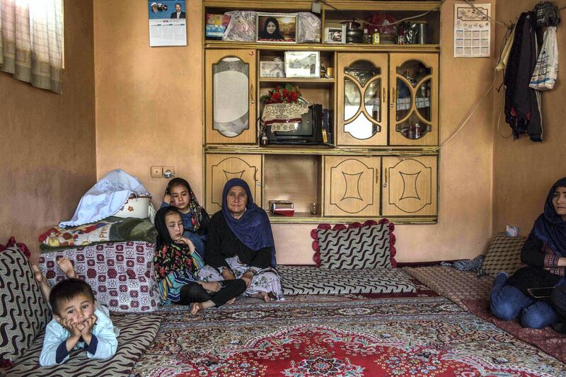 Soraya Gul's family at home, with a picture of her framed. Courtesy of the Gul family