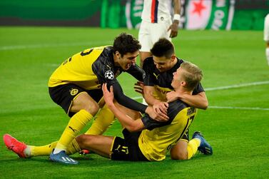 Erling Haaland is congratulated by his Dortmund teammates Giovanni Reyna and Raphael Guerreiro after scoring the first goal against PSG. AFP
