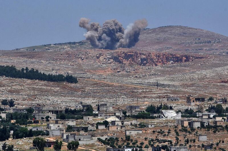 This picture taken on May 17, 2019 from the Syrian town of Qalaat al-Madiq, some 45 kilometres northwest of the central city of Hama, shows bombardment by Syrian government forces on the Shashabo Mountain.  AFP