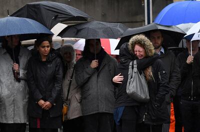 A woman reacts as people observe a minutes' silence at south-side of London Bridge in London on June 6, 2017, in memory of the victims of the June 3 terror attacks.
Police on Monday identified two of the three London attackers as Khuram Butt and Rachid Redouane, after Britain's third terror assault in less than three months, as Prime Minister Theresa May came under mounting pressure over security just days ahead of elections. / AFP PHOTO / Justin TALLIS
