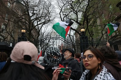Demonstrators wave Palestinian flags outside an entrance to the Columbia University campus in New York City. Reuters