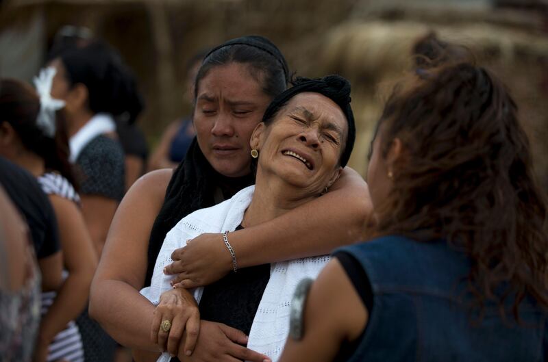 Mourners grieve at a funeral service for 90-year-old Hermilo Martinez, who died from shock following Thursday's magnitude 8.1 earthquake in Mexico. Rebecca Blackwell / AP Photo
