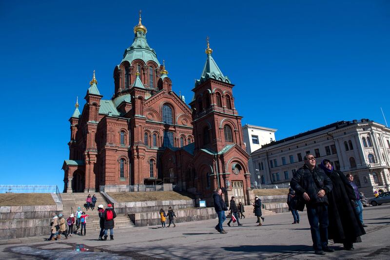 Tourists take photographs in front of Russian Orthodox Uspenski Cathedral on March 30, 2018 in Helsinki, Finland. (Photo by Chris J Ratcliffe/Getty Images)