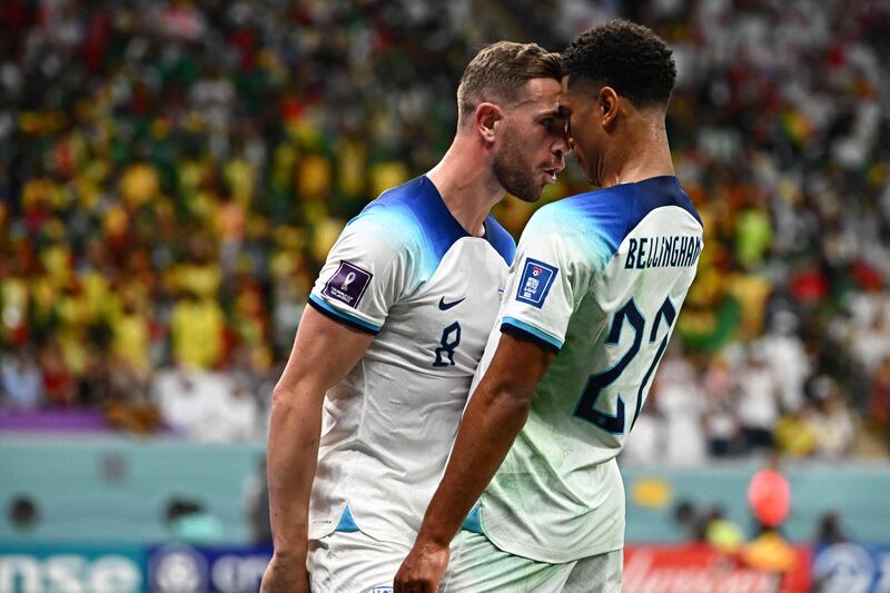 England's Jordan Henderson celebrates scoring their first goal with Jude Bellingham. AFP