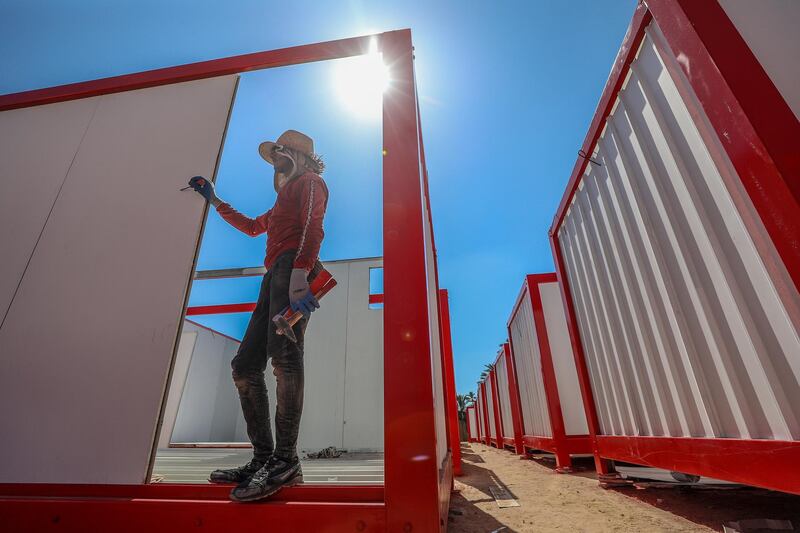 A Palestinian worker helps builds a new quarantine field hospital for patients suffering from Covid-19 in the town of Deir Al Balah, southern Gaza Strip. EPA