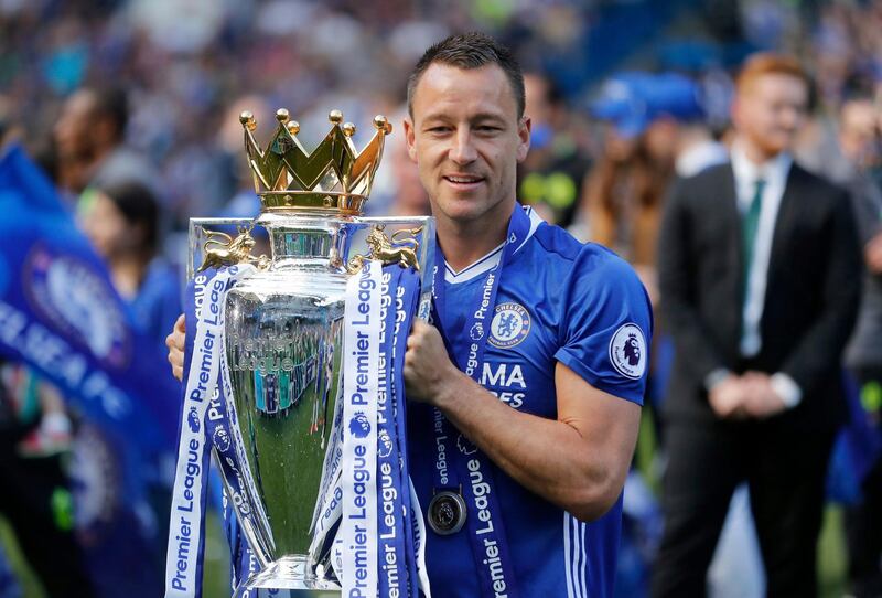 FILE - In this Sunday, May 21, 2017 file photo Chelsea captain John Terry holds the trophy after they won the league, following the English Premier League soccer match between Chelsea and Sunderland at Stamford Bridge stadium in London. Former Chelsea and England captain John Terry has announced his retirement. "After 23 incredible years as a footballer, I have decided now is the right time to retire from playing," Terry said on his official Instagram account on Sunday Oct. 7, 2018. (AP Photo/Frank Augstein, File)