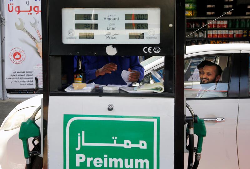 A worker writes a receipt at a petrol station in Jeddah, Saudi Arabia. AP Photo