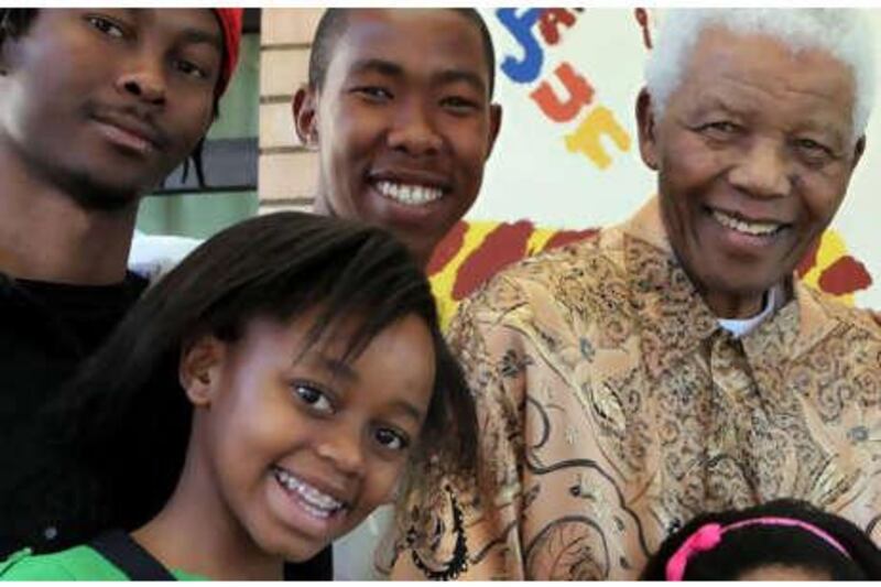 Former South African president Nelson Mandela, top right, with his great-grandson Thembela Mandela, top left, grandson Mbuso Mandela, top centre, great-granddaughter Zenani Mandela, in the foreground, at the Mandela foundation in Johannesburg.