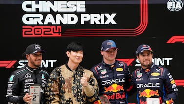 Singapore singer JJ Lin, second left, stands with sprint race winner Red Bull driver Max Verstappen of the Netherlands, second placed Mercedes driver Lewis Hamilton, left, of Britain and third placed Red Bull driver Sergio Perez, right, of Mexico at the Chinese Formula One Grand Prix at the Shanghai International Circuit, Shanghai, China, Saturday, April 20, 2024.  (AP Photo / Andy Wong)