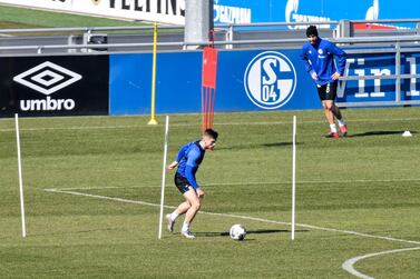 Due to the coronavirus outbreak at most two players of the German first division, Bundesliga, soccer club Schalke 04 exercise together to keep distance during the training on the club's training ground in Gelsenkirchen, Germany, Tuesday, April 1, 2020. The German Football League (DFL) announced all matches will be suspended until at least 30th April due to the ongoing coronavirus pandemic. The new coronavirus causes mild or moderate symptoms for most people, but for some, especially older adults and people with existing health problems, it can cause more severe illness or death. (AP Photo/Martin Meissner)