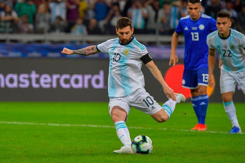 Argentina's Lionel Messi takes a penalty awarded by the VAR after a hand in the area, to score against Paraguay during their Copa America football tournament group match at the Mineirao Stadium in Belo Horizonte, Brazil, on June 19, 2019. / AFP / Luis ACOSTA
