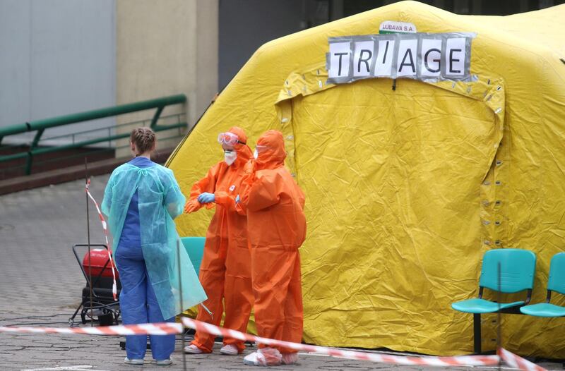 Medics wait outside a special tent during the coronavirus disease outbreak, outside a hospital in Warsaw, Poland. Reuters