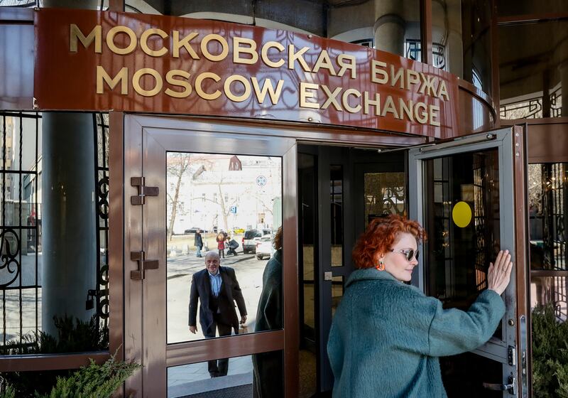 A woman enters the Moscow Exchange in Russia. The country partially resumed some stock trading on March 24 after a near month-long hiatus. EPA